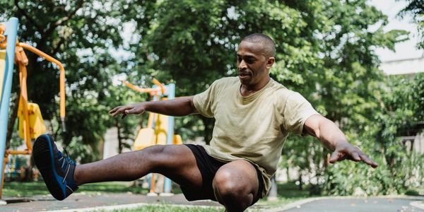 Man performing a single-leg balance exercise.